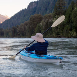 Kayaking in a river surrounded by Canadian Mountains Kayaking in a river surrounded by Canadian Mountains during a vibrant summer sunset. Taken in Squamish, British Columbia, Canada.